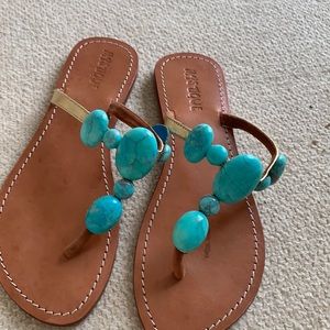A pair of beach sandals in gold and turquoise in a very good condition. Size9